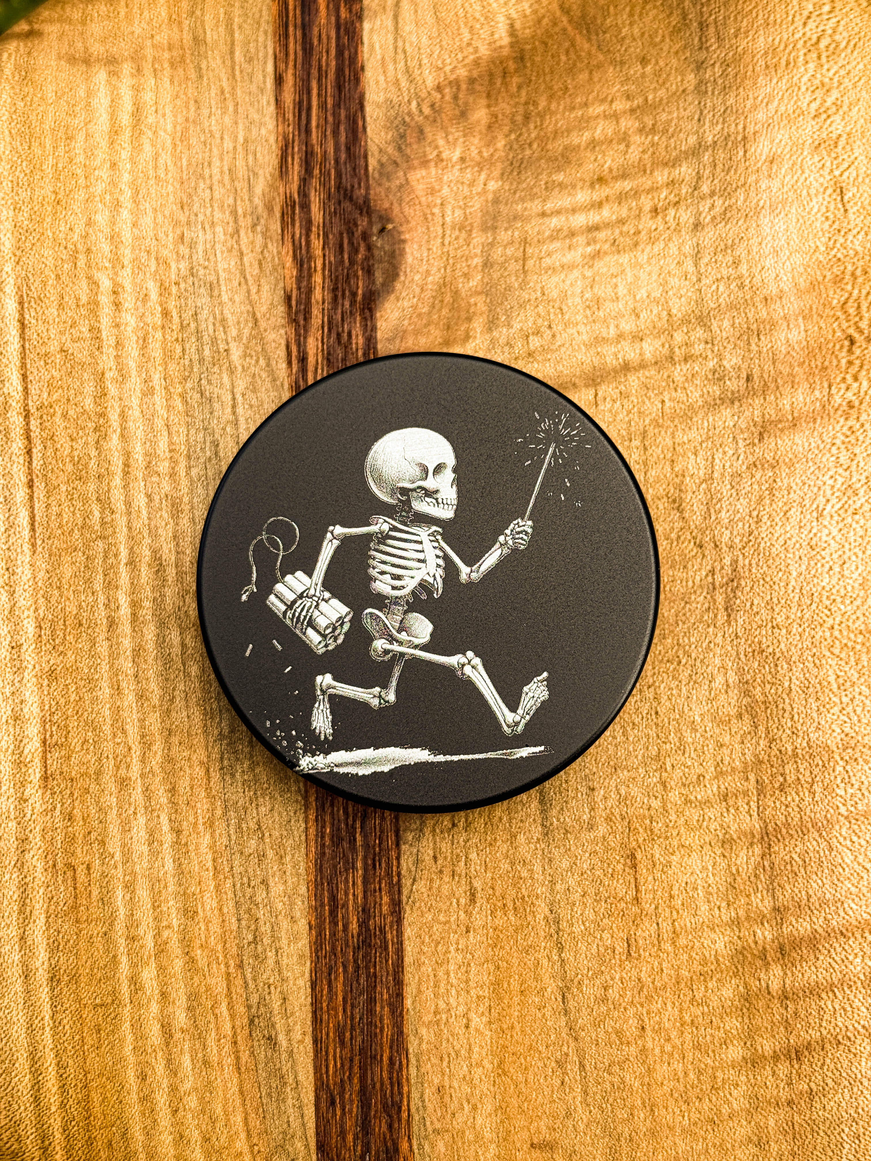 Metal Zyn Can for nicotine pouches with a skeleton carrying a sparkler and dynamite engraved design. With integrated bottle opener. 