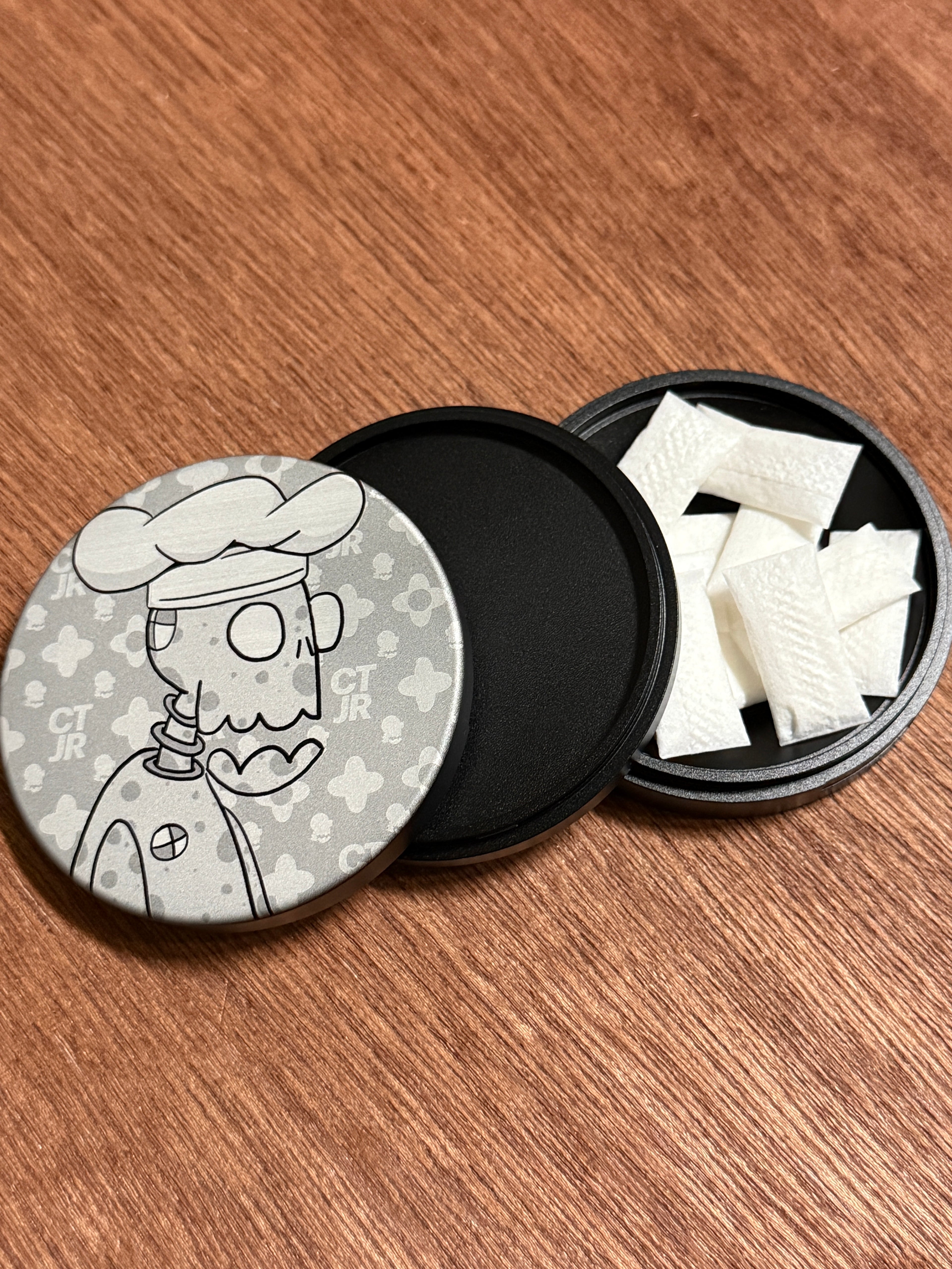 Metal Zyn Can for nicotine pouches with engraved design of desert cartoon Crash Test Joy Ride character. With integrated bottle opener. 