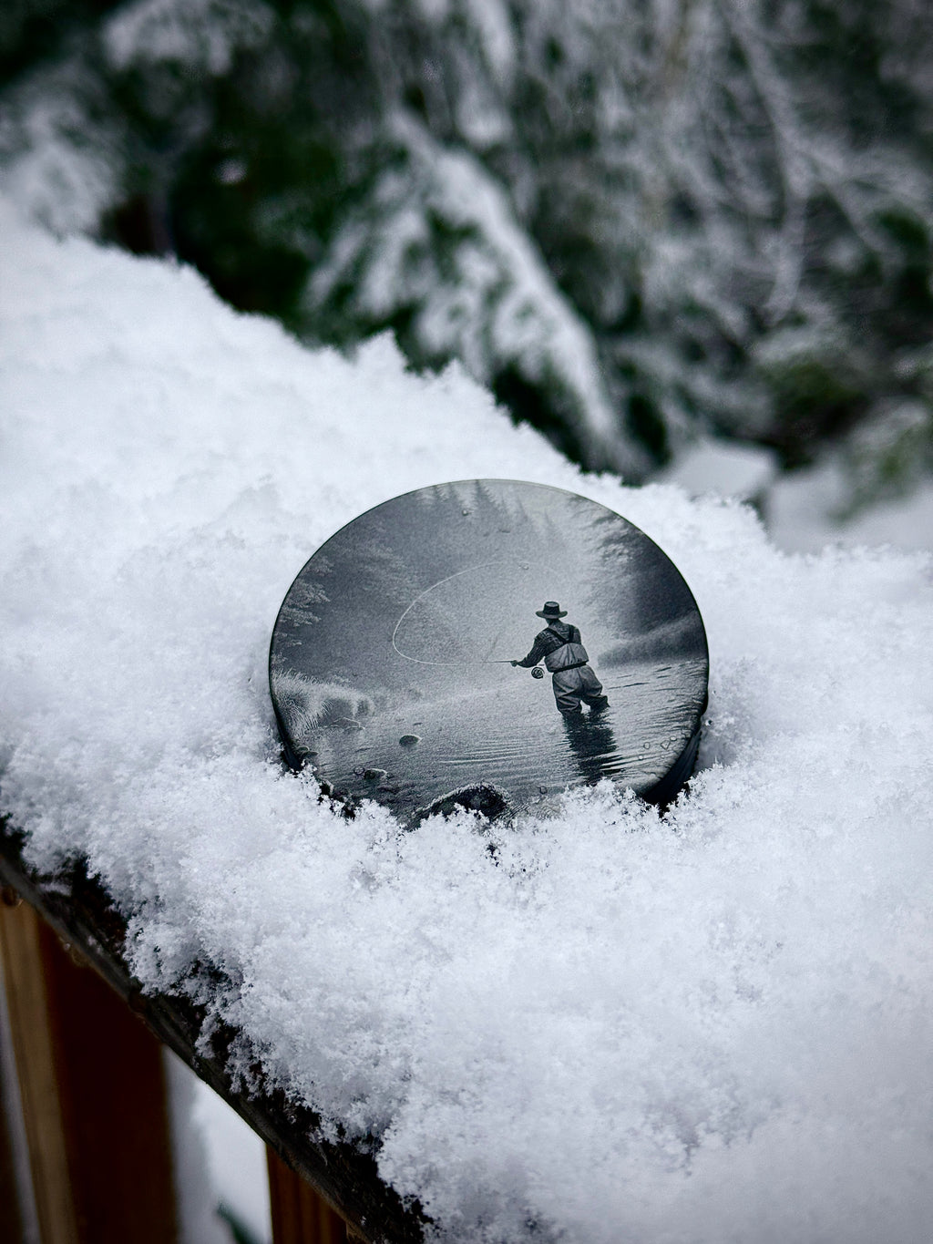 Metal Zyn Can for nicotine pouches with Fly fishing engraved design. With integrated bottle opener. Displayed in snow 