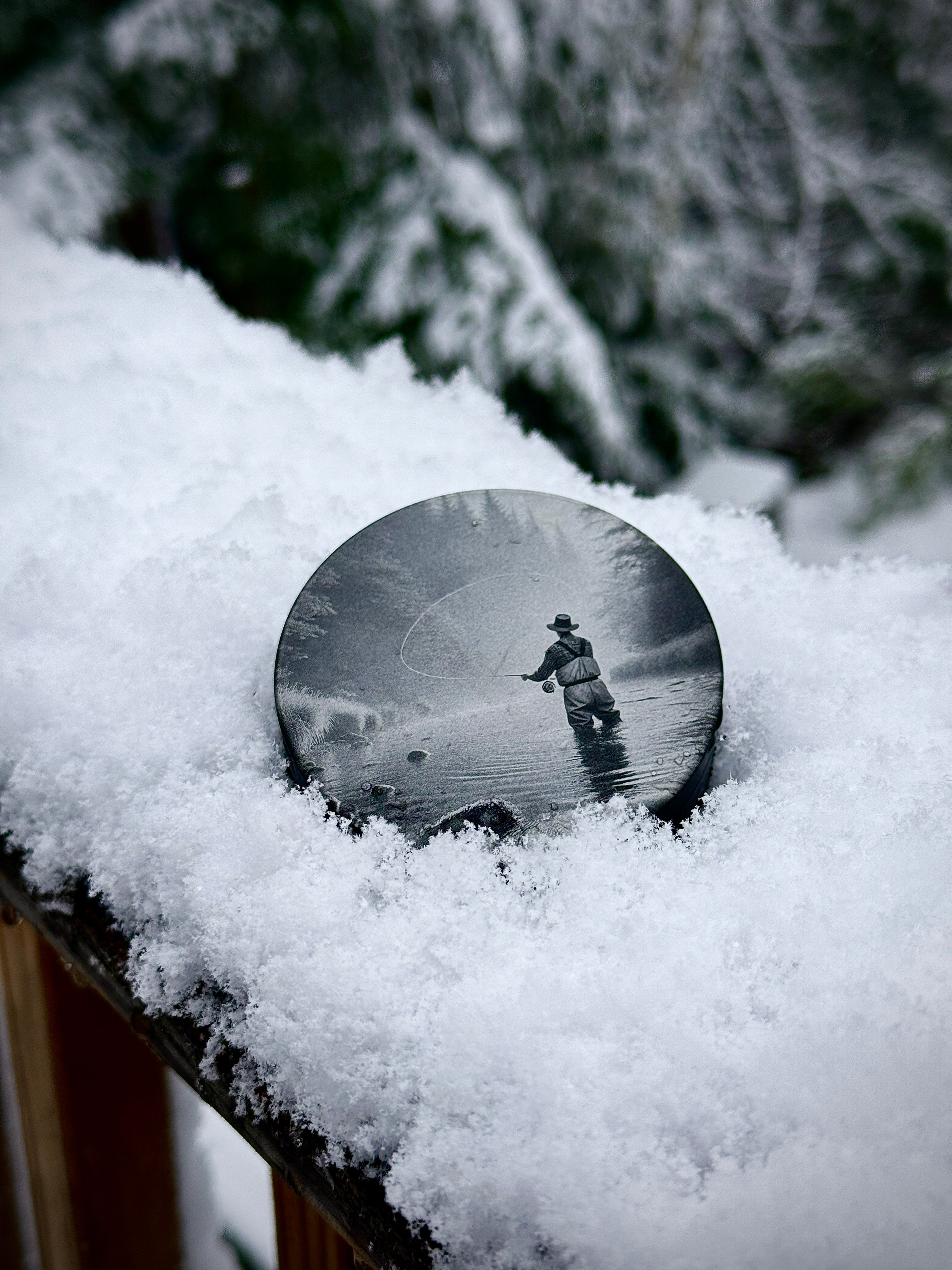 Metal Zyn Can for nicotine pouches with Fly fishing engraved design. With integrated bottle opener. Displayed in snow 