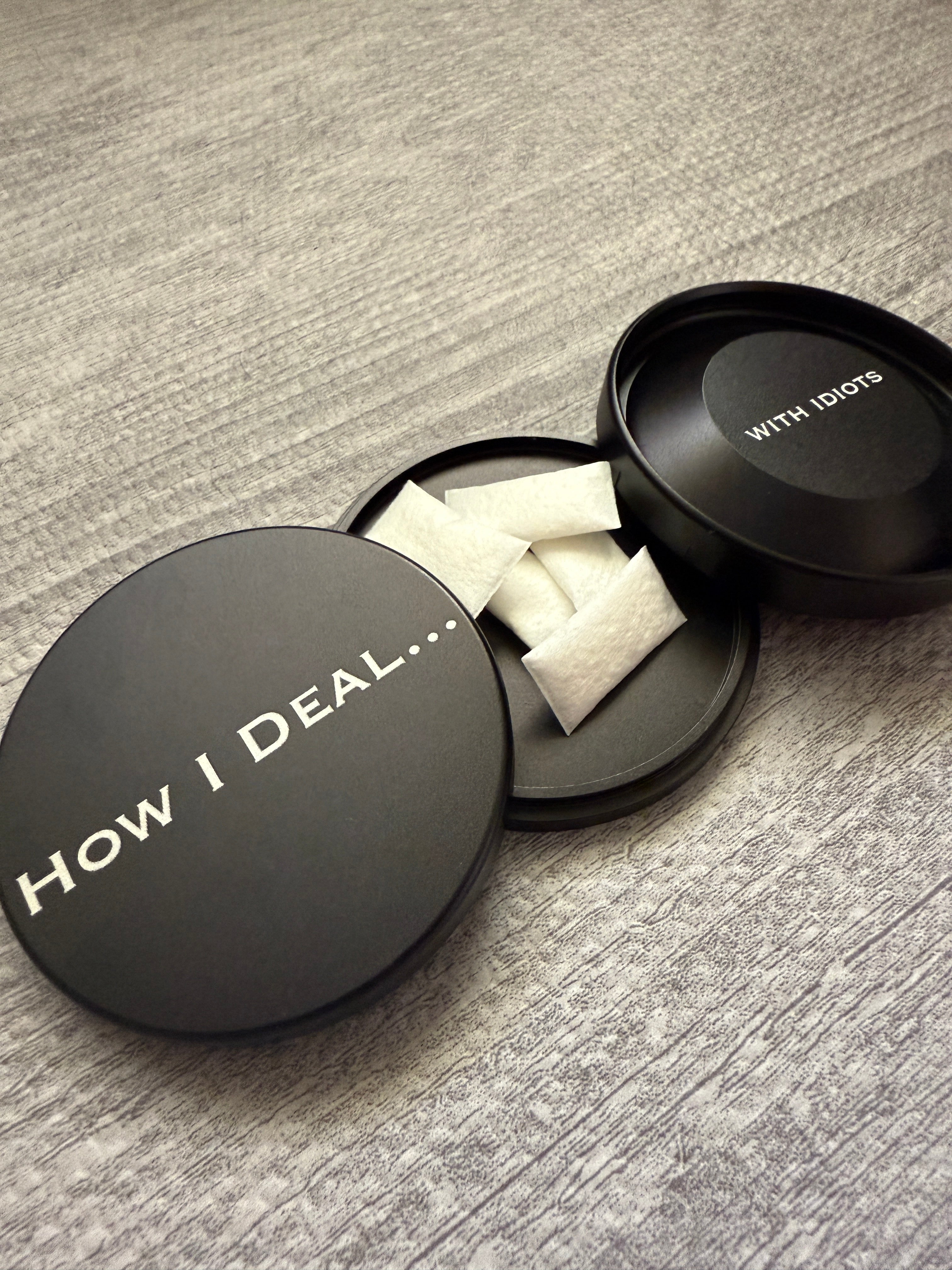 Metal Zyn Can for nicotine pouches with engraved design "How I deal... with idiots". With integrated bottle opener. 