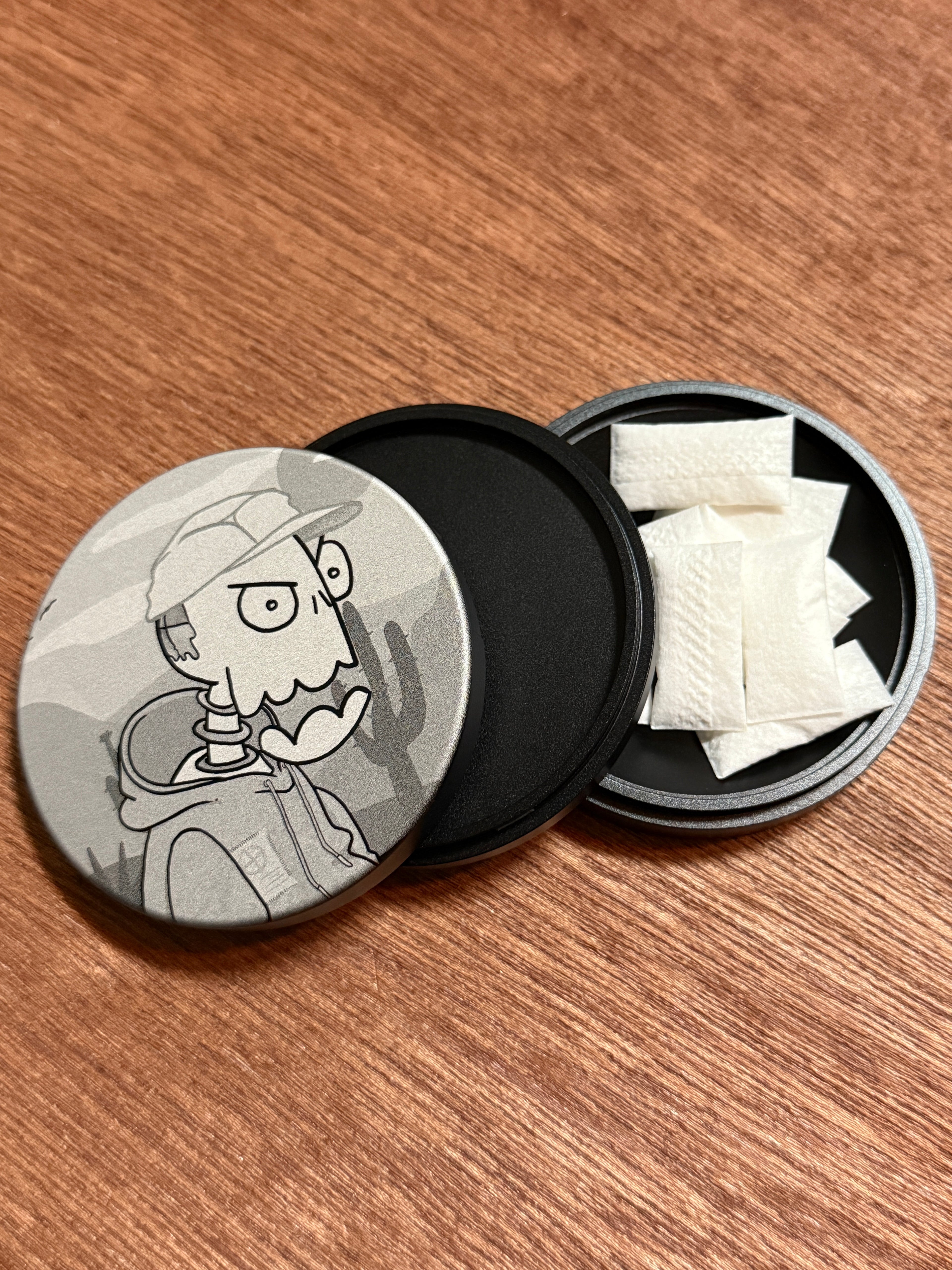 Metal Zyn Can for nicotine pouches with engraved design of desert cartoon Crash Test Joy Ride character. With integrated bottle opener. 