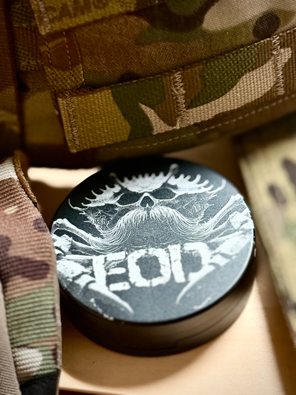 Metal Zyn Can for nicotine pouches with engraved design of an EOD crab with a mustache. With integrated bottle opener. 