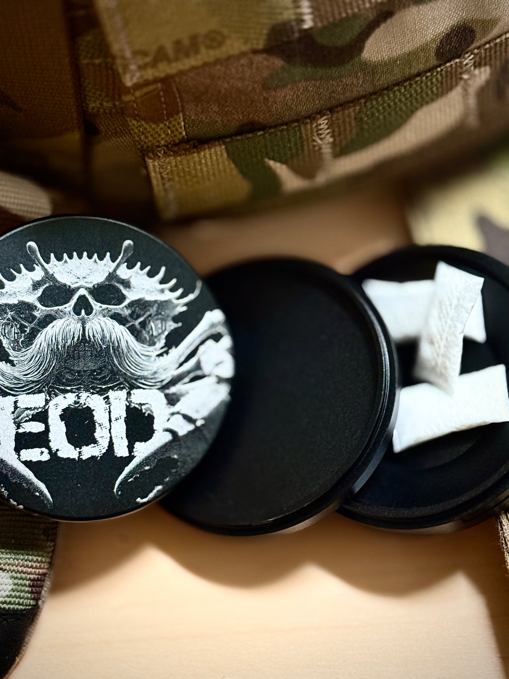 Metal Zyn Can for nicotine pouches with engraved design of an EOD crab with a mustache. With integrated bottle opener. 