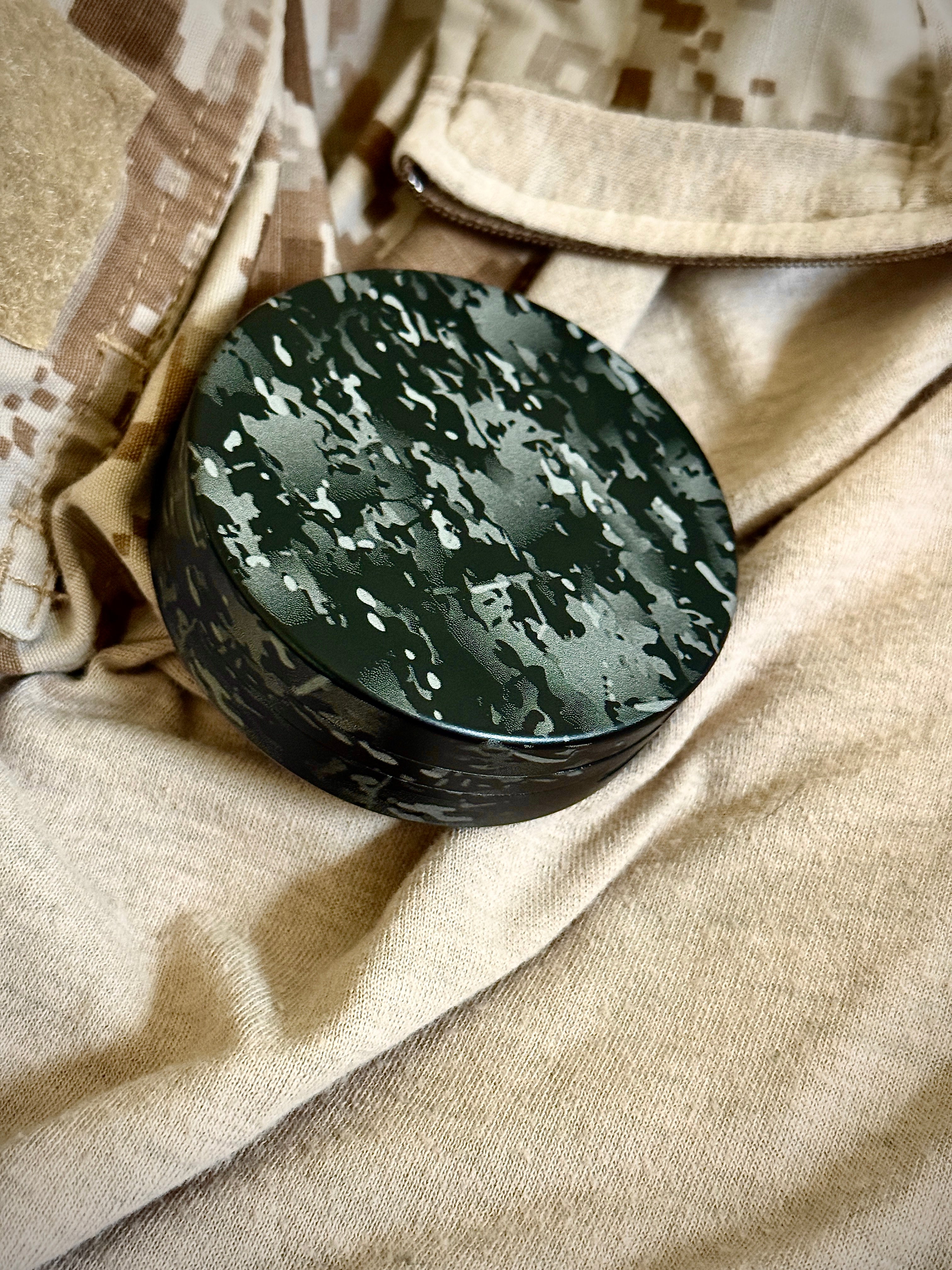 Metal Zyn Can for nicotine pouches completely engraved with camouflage design. With integrated bottle opener. Displayed on crye camouflage uniform.
