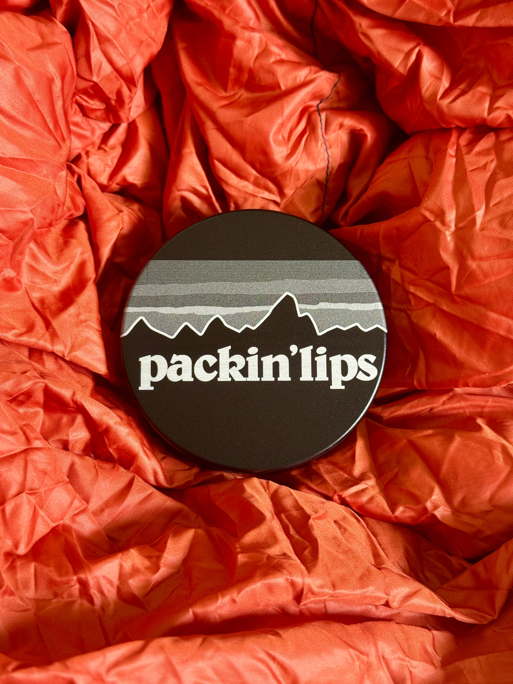 Metal Zyn Can with engraved design that says "packing lips" with integrated bottle opener.