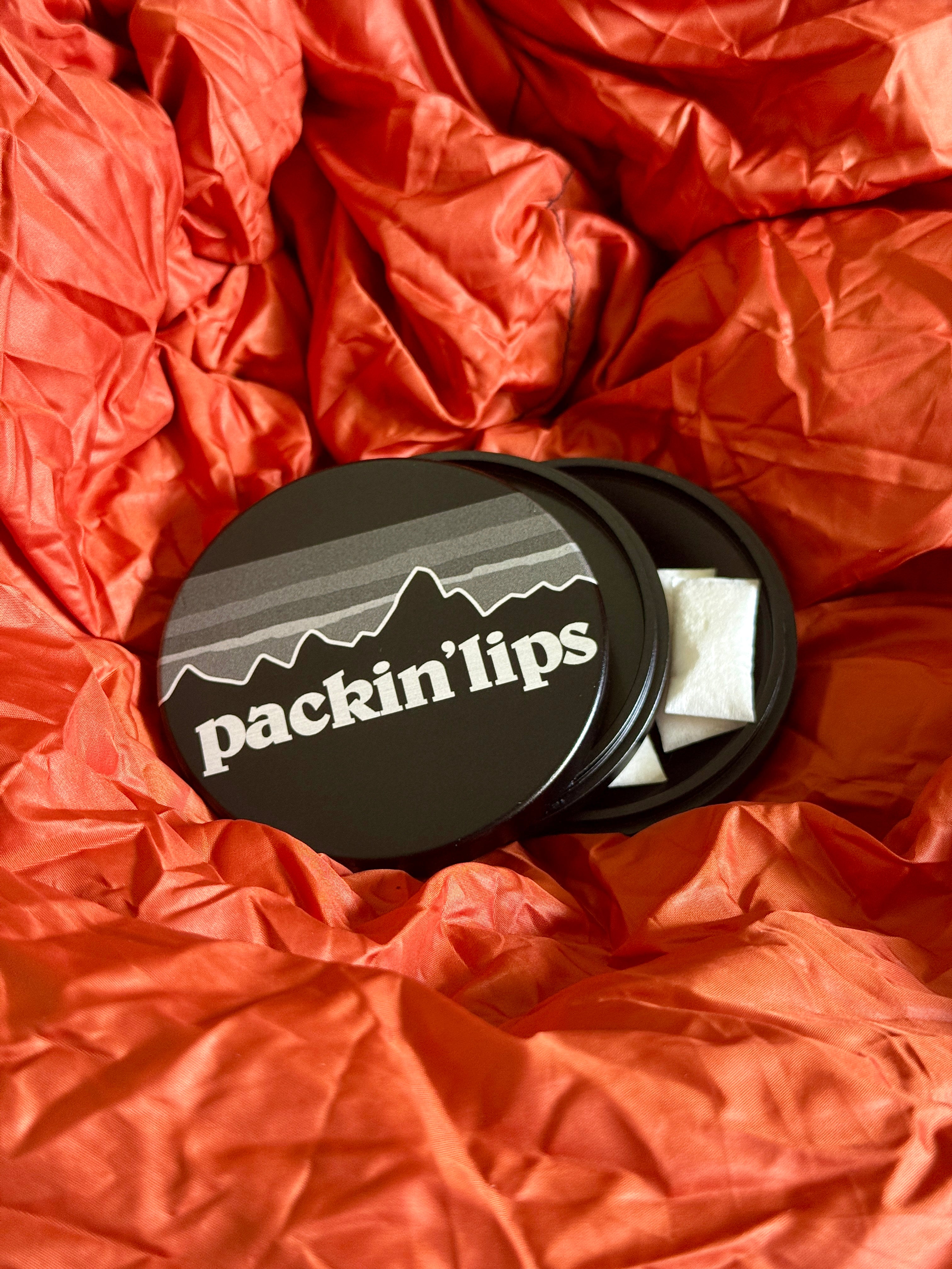 Metal Zyn Can with engraved design that says "packing lips" with integrated bottle opener.